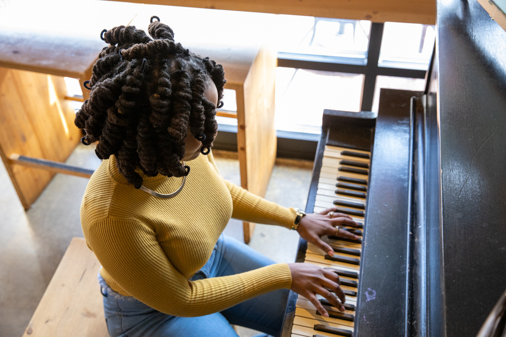 Woman with Dreadlocks Playing the Piano